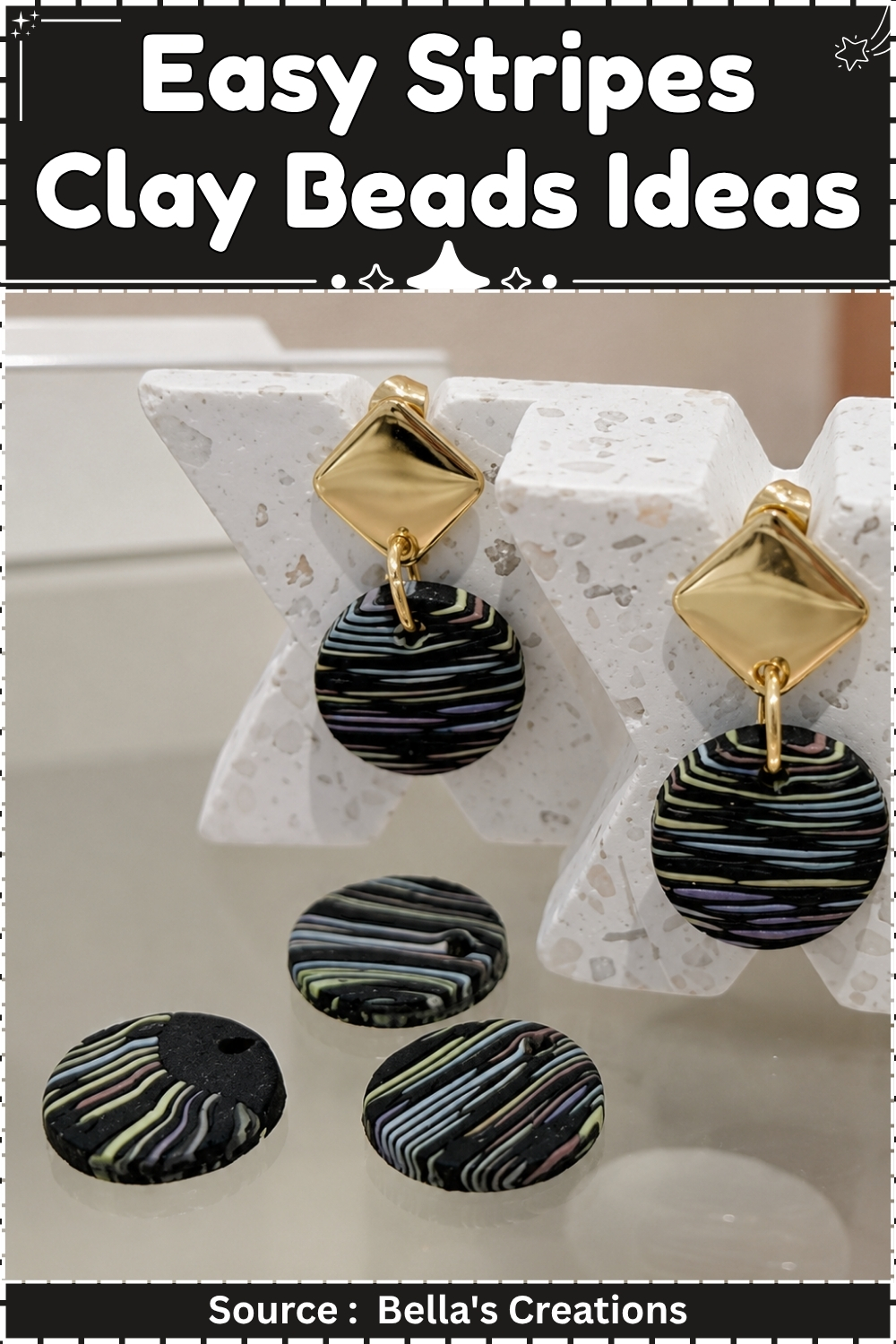Black polymer clay beads with pastel stripe patterns hanging from gold stud earrings beside loose round clay discs