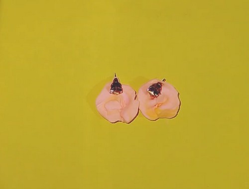 A finished boho ruffled clay stud earring showing the crystal centre and raised petal texture.