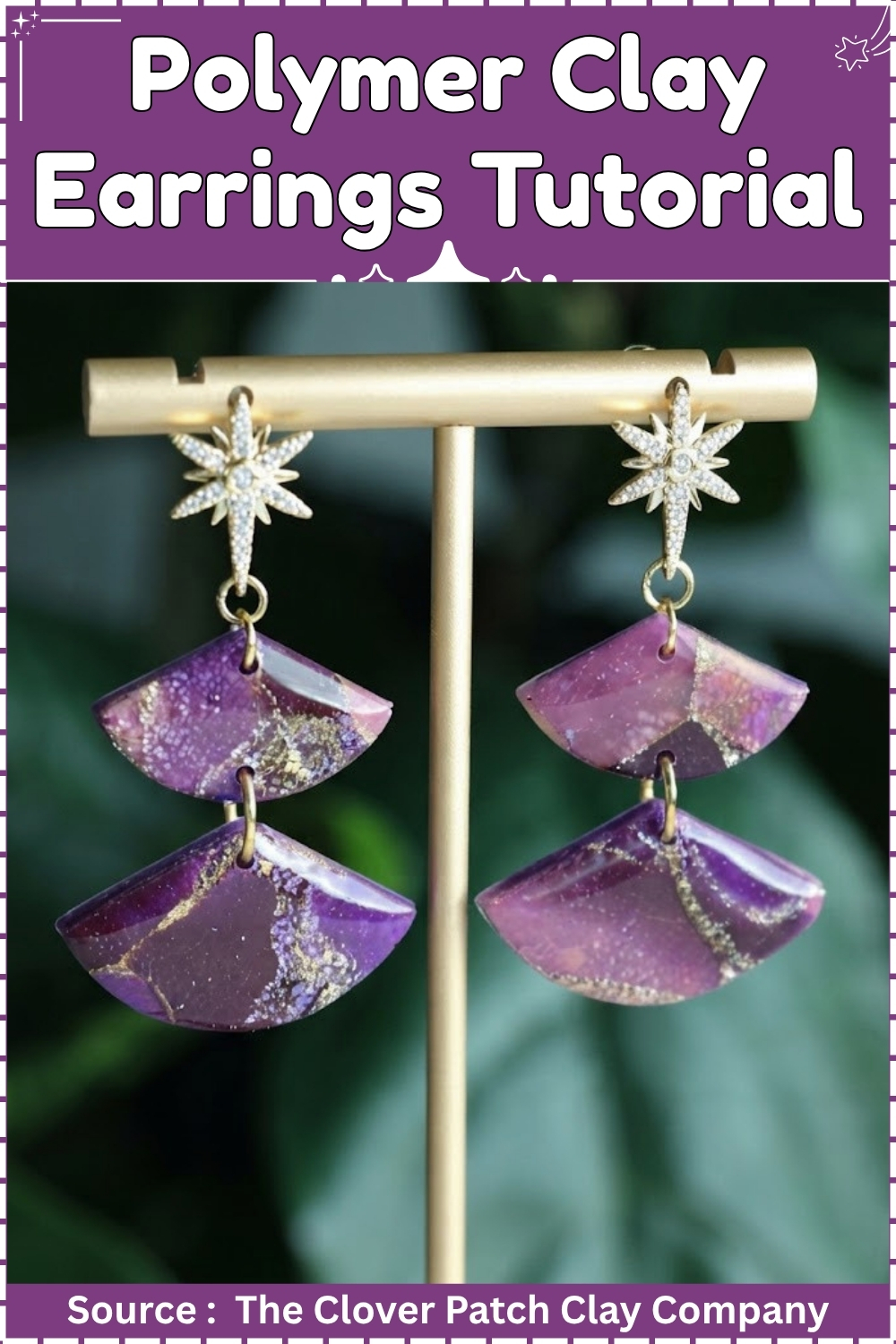 Two-tier fan-shaped polymer clay earrings in deep purple with gold glitter veining hanging from crystal star studs on a gold earring display stand against green foliage. 