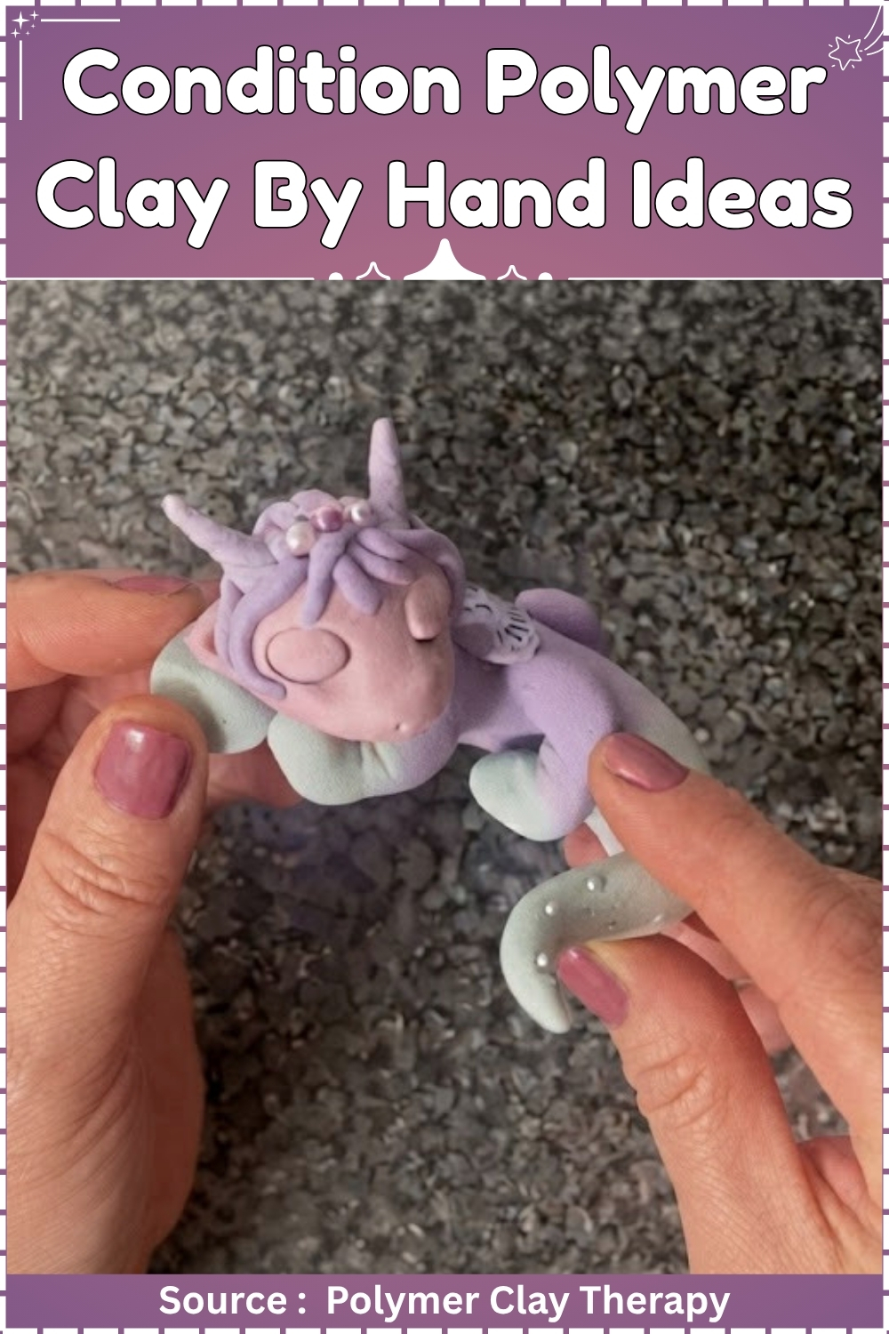 Hands holding a small finished polymer clay unicorn figurine in lavender and mint green with pearl bead details and a twisted horn over a gray gravel background.