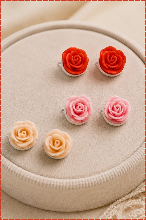 Two matching polymer clay rose stud earrings finished with clear dew drops.